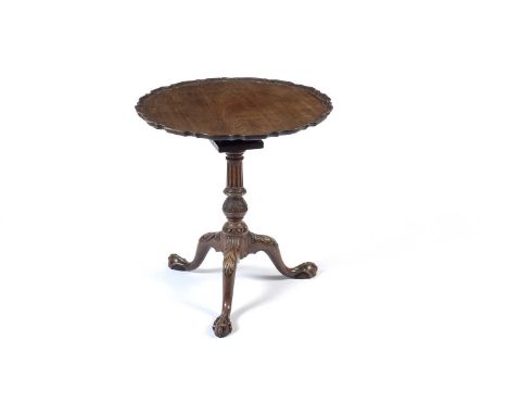 A George III style well-carved mahogany tilt-action tripod table, with circular piecrust top, the birdcage below on a fluted 