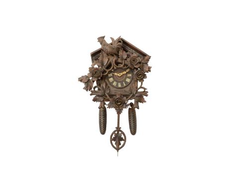 A Swiss carved oak cuckoo wall clock, late 19th century, the skeletonized two-train movement with bellows and escapement stam