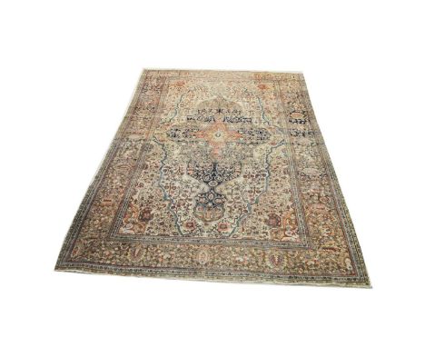 An early 20th Century Kirman carpet, with geometric scrolls to shaped field and spandrels, 356 x 259cms. Provenance: select i