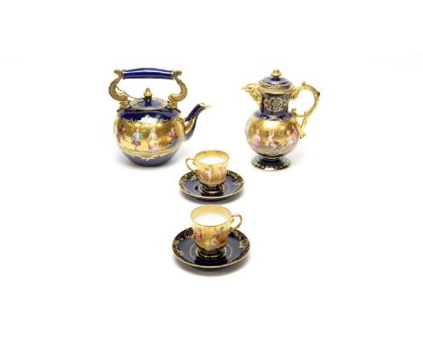 A Vienna blue ground part tea service, circa 1900, comprising : tea kettle with double gilt metal dolphin mounts, painted wit