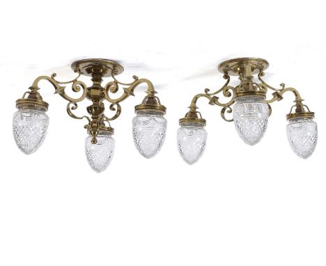 RMS Olympic interest: a fine pair of brass three branch ceiling light fittings, of scrolling form with cut glass 'acorn' shad