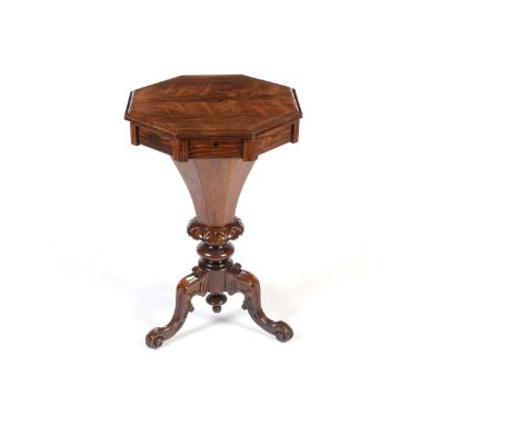 A Victorian rosewood tripod worktable, the octagonal hinged and moulded cover opening to reveal a fitted interior, tapering o