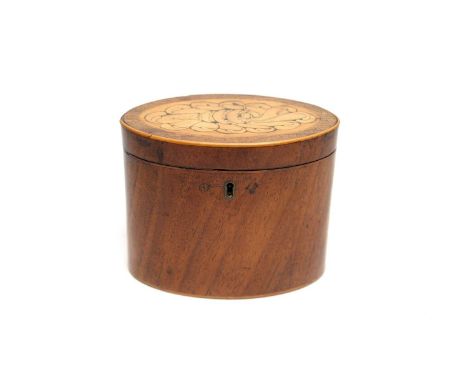 A George III mahogany tea caddy, oval with shell paterae and boxwood stringing, 15cms wide.