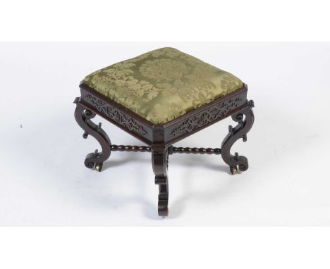 An attractive 19th Century mahogany footstool, the drop-in seat upholstered in green damask fabric, blind fretwork decoration