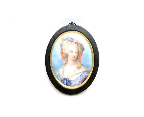 A late 19th Century French Sevres style oval portrait plaque with a shoulder length portrait of Marie Antoinette, within maho