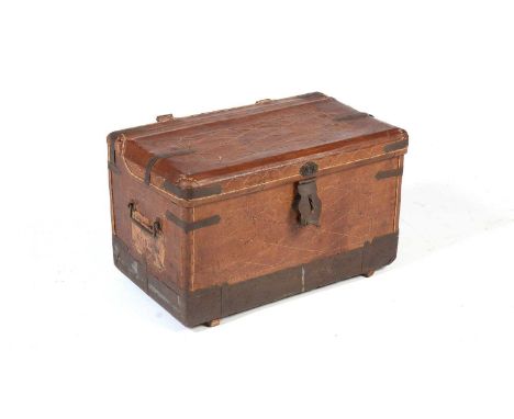 A vintage leather and metal bound travelling trunk, with geometric stitching overall and remnants of old labels, the hinged c