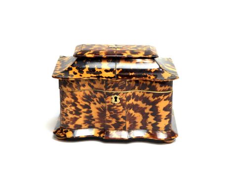 A George III tortoiseshell tea caddy, of serpentine form with interior covers, 20cms wide.