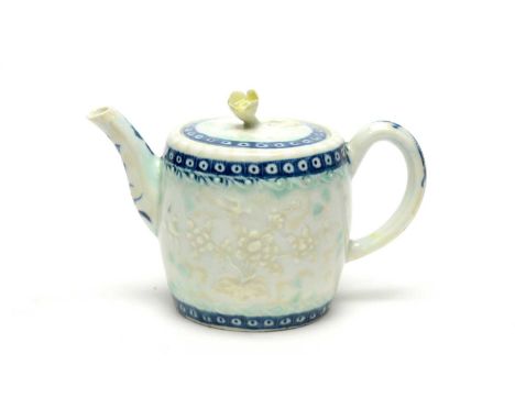 A Worcester barrel-shaped teapot, circa 1770, with flower finial, moulded with oriental style flowers within a blue cellular 