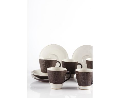Lucie Rie (1902-1995) Set of five cups and six saucers, 1956 the cups horizontally incised on manganese ground each impressed