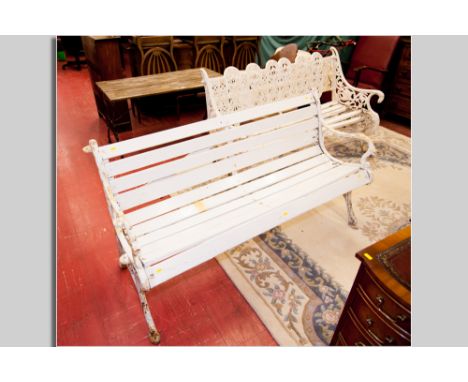 A 19th Century white painted cast iron, possibly Coalbrookdale, garden bench, the back of six oval panels with scrolling and 