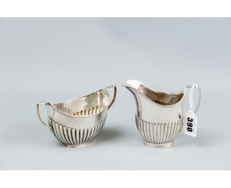 A silver twin handled sugar basin of reeded form with matching cream jug, 7.2 ozs, London 1903