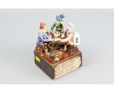 A Will Young Widecombe pottery figural group of card playing gents, 'Widecombe Fair Verse' to the front, music box base, sign