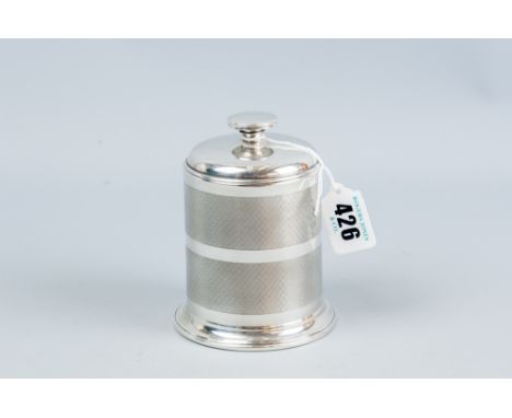 A brass and bakelite carousel cylindrical cigarette dispenser, the outer casing of engine turned silver and with silver lid, 