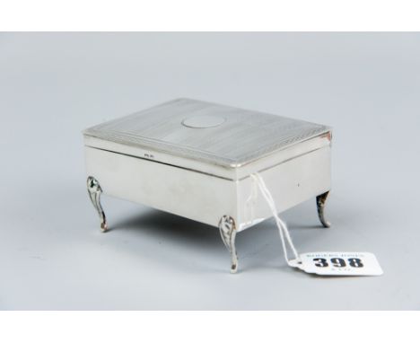 A small plain silver slightly oblong ring box with engine turned lid and on four corner supports, 5.3 ozs gross, Birmingham 1