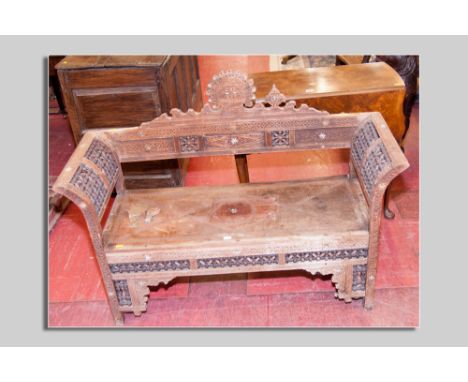 An Eastern hardwood bobbin patterned bench with carved back and curved ends (faded, for restoration) and a reproduction walnu