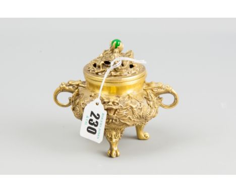 A cast gilt metal sensor and cover with mask and dragon decoration on lion mask and paw feet, the pierced lid with central po