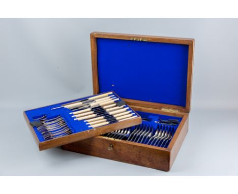 A sixty piece canteen of cutlery, knives with bone handles by Harrison Brothers & Howson with brass presentation inscription 