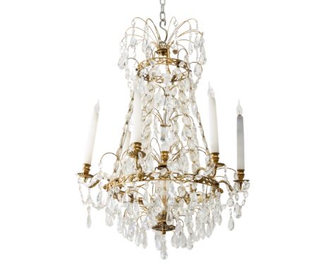 A gilt-bronze and glass chandelier, of Swedish style, second half 20th century, the scroll circlets with lion-head mounts and