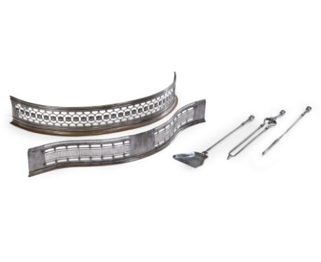 A group of English steel fireside accessories, 19th century, comprising: a pierced serpentine fender, 110cm wide; a pierced c