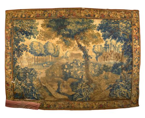 A Flemish verdure tapestry, late 17th / early 18th century, woven with a peacock, eagle and exotic birds to the foreground wi