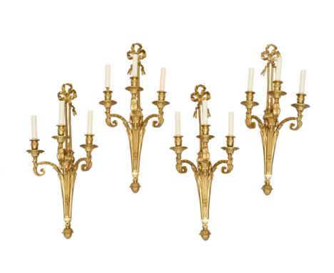 A set of four large gilt-bronze three-light wall appliques, of Louis XVI style, second half 20th century, each ribbon-tied ba