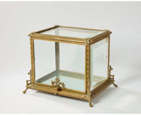 A French brass 'Japonisme' glazed table top display case, early 20th century, cast with bamboo to the angles, later mirrored 