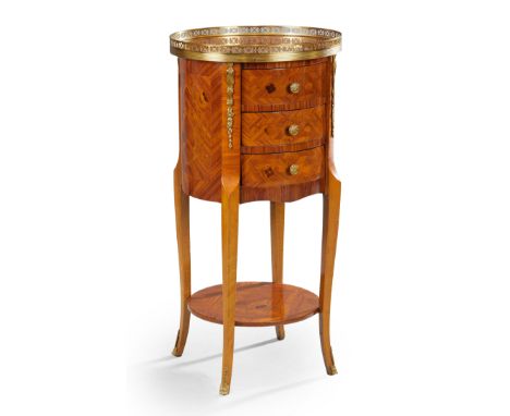 A French inlaid tulipwood circular side chest, of Louis XV style, first half 20th century, with brass gallery top above three