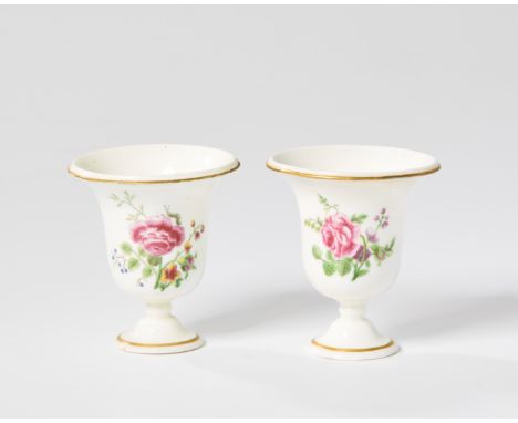 A pair of Vincennes porcelain campana-shaped miniature vases, c.1745-50, blue interlaced L cypher marks and dot marks, painte