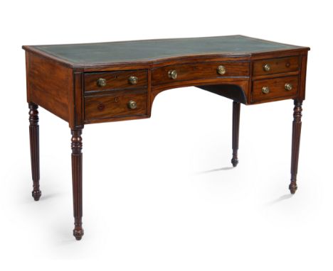 A George IV mahogany concave front writing table, first quarter 19th century, the top with tooled leather surface and reeded 