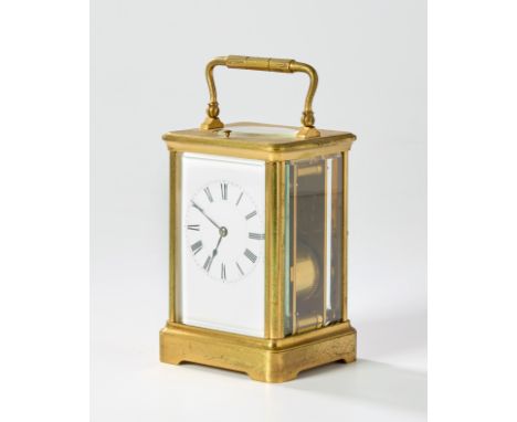A brass repeating carriage clock, late 19th century, with swing handle and bevelled glass panels, the white enamel dial with 