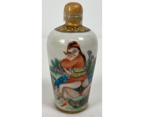 A Chinese ceramic snuff bottle with erotic scene painted to front. Signature mark to base. Approx. 9cm tall.  