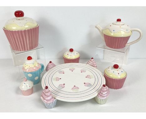 A quantity of assorted modern novelty cupcake design kitchen ceramics. To include: cake stand, lidded storage jars, teapot an