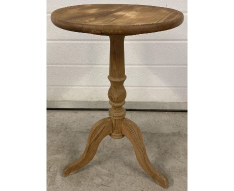 A vintage pine circular topped tripod legged occassional table. Approx. 57.5cm tall x 36.5cm diameter.  