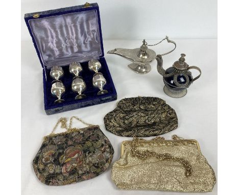 3 ladies vintage evening bags together with 3 ethnic metal items. A boxed set of eggcups with hammered detail, a white metal 