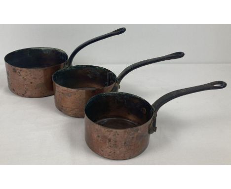 A set of 3 vintage graduating French copper saucepans with riveted handles. Largest approx. 16cm diameter.  