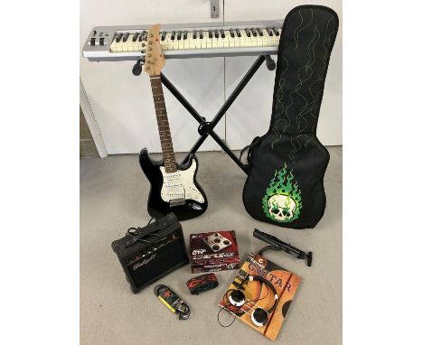 A modern music bundle to include guitar, keyboard and amp. Comprises: black &amp; white 'Fortissim' guitar, soft guitar case 