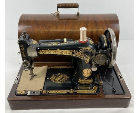 A vintage wooden cased Singer hand sewing machine with gilt detail. Complete with "Sew-Tric" motor and lamp, electric foot pe