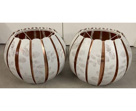 A pair of modern copper and white patterned metal globe style ceiling light shades. Approx. 30cm tall x 38cm diameter.  