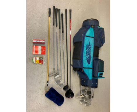 A large Sigma Gold White Shark golf club bag with carry straps together with a collection of golf clubs and accessories. Club