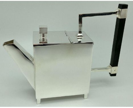 A silver plated Christopher Dresser style teapot of Art Deco design. Abstract form, raised on 4 small square legs and with wo