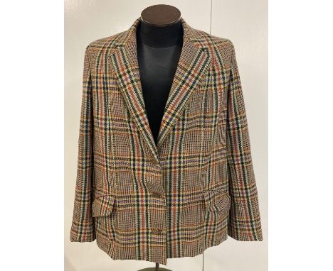 A ladies tweed jacket with button fastening by E. Abington &amp; Sons Ltd, Kimbolton. In tan, red, black and blue colourway. 