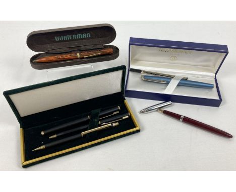 A collection of vintage and modern pens and pencils. Comprising a vintage Waterman's Ideal propelling pencil with wood effect