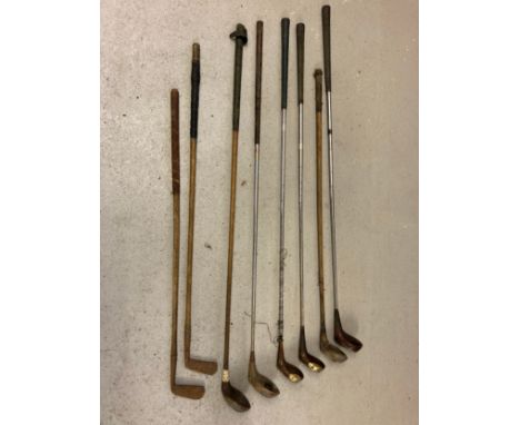 A collection of vintage golf drivers and putters in varying conditions. To include J. P. Cockrane Edinburgh, Dunlop, Eric Bro