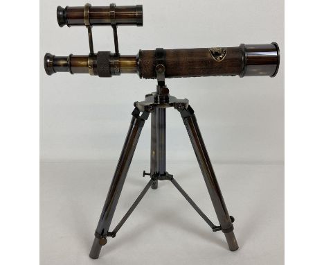 An ornamental desk top brass telescope with folding tripod stand. Telescope marked 'Kelvin &amp; Hughes, London 1917'. Height