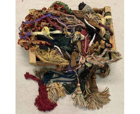 A box of vintage and modern tassels, braids and decorative edging material for upholstery work.  