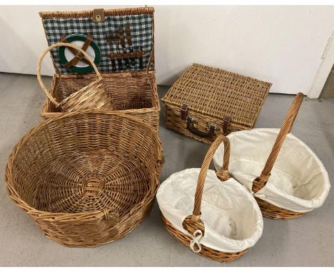 A collection of wicker items. Comprising: a picnic basket with 2 plates, knives and fork and bottle opener, a square picnic b