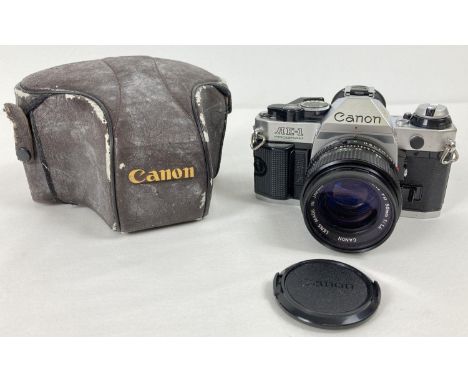 A Canon AE-1 Program camera with Hoya Skylight Canon Lens FD 50mm 1:1.4 and cover case. The cover case exterior very worn. Se