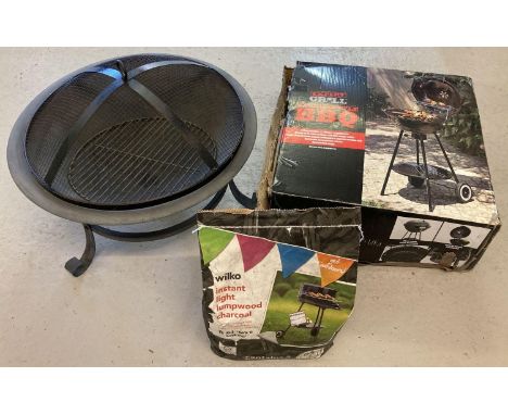 A boxed new and unassembled 43cm kettle BBQ. Together with a fire pit with grill and an unopened bag of charcoal.  
