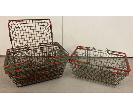 6 vintage wire shopping baskets with red and green plastic grip handles.  