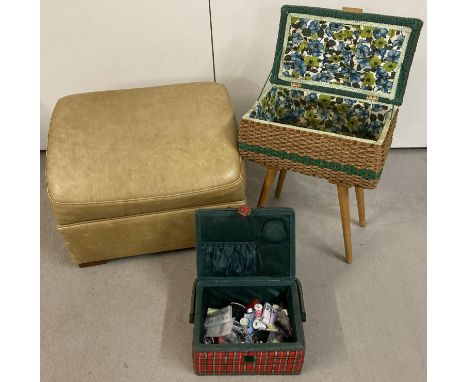 A vintage leather footstool together with a vintage wicker sewing box on 4 legs with floral interior and a red and green tart